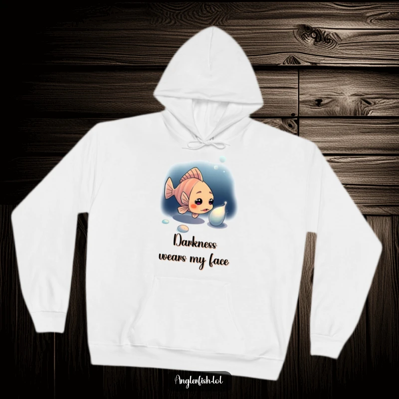 Funny anglerfish hoodie depicting a curious anglerfish looking at a shiny, unknown item in the deep dark ocean.