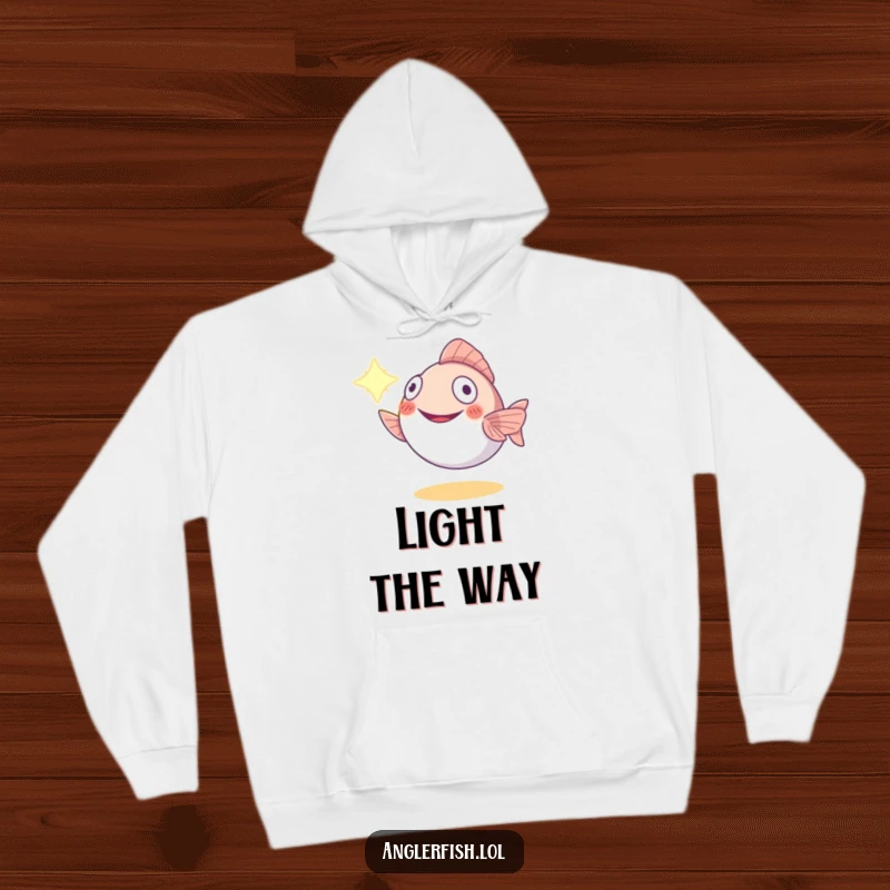 Funny anglerfish hoodie featuring a happy creature using its lure as a lamp to guide the way, offering comfort and humor.