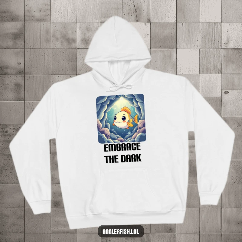 Funny hoodie showing a curious anglerfish shining its light into a vast, mysterious cavern filled with stars, evoking a sense of wonder.