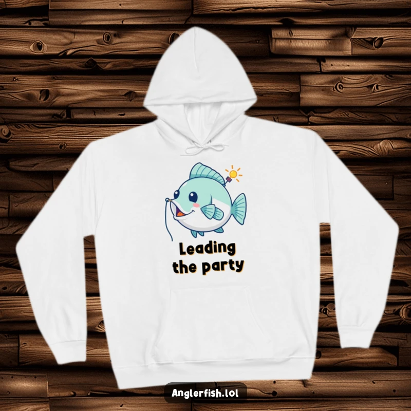 Funny hoodie showing a playful anglerfish using its lure as a whimsical guiding beacon, perfect for cozy, humorous exploration.